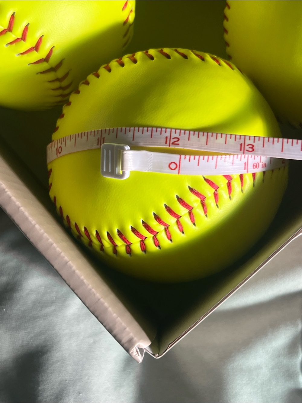 Bright Neon Yellow Softball with Red Stitching